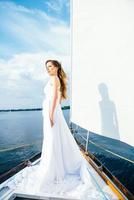 young girl on deck of sailing wooden yacht photo