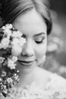 bride with a wedding bouquet in the forest photo