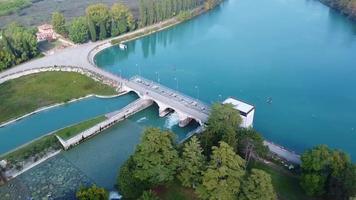 Flying over the river Dam with plain landscape and trees video