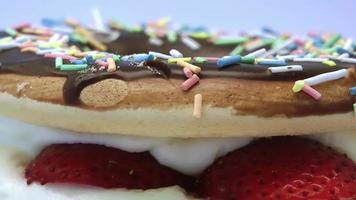 Strawberry Cake Covered With Creamy Colorful Candies Rotating Footage video