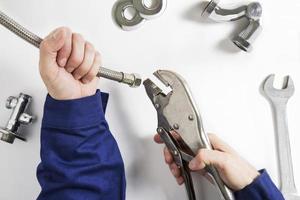 hands of plumber at work photo