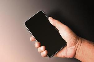 Man hand holding blank isolated smartphone background photo