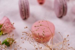 Beautiful pink tasty macaroons on a concrete background photo