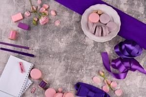 Beautiful pink tasty macaroons on a concrete background photo