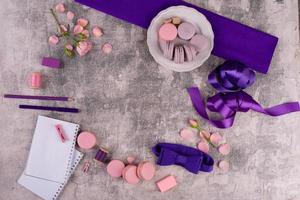 Beautiful pink tasty macaroons on a concrete background photo