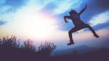 Jumping posture happy holidays Nature trails, forests, mountains photo