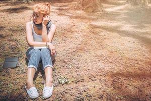 Woman relaxing reading in park. holiday photo