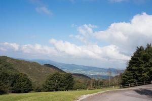 Recreational area near Oviedo. Empty road and nature around. Trees and mountains, sunny day, no people. Asturias. photo