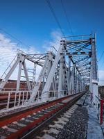 Railroad bridge of metal beams. photo