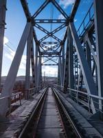 Railroad bridge of metal beams. photo