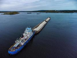 Aerial view of loaded dry cargo ship on river.