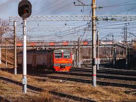 Old passenger train traveling through the industrial area. photo