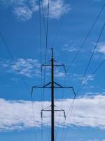 Electrical high-voltage tower on cloudy sky background. photo