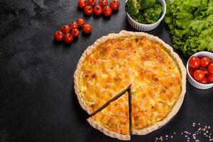 Delicious fresh quiche with broccoli, salmon and cheese photo