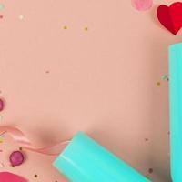Party Holiday Background with ribbon, stars, birthday candles, empty frame and confetti on pink background. Photo