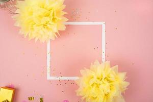 Party Holiday Background with ribbon, stars, birthday candles, empty frame and confetti on pink background. Photo