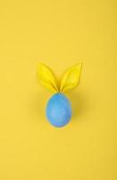 Egg with paper ears in the shape of an Easter bunny. Happy Easter Concept Card Postaer Background photo