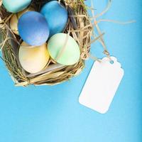 Colorful background with Easter eggs on blue background. Happy Easter concept. Can be used as poster, background, holiday card. Flat lay, top view, copy space. Studio Photo