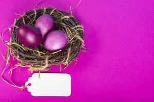 Colorful background with Easter eggs on pink background. Happy Easter concept. Can be used as poster, background, holiday card. Flat lay, top view, copy space. Studio Photo