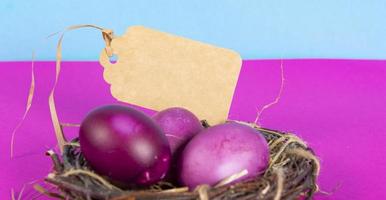 Colorful background with Easter eggs on pink and blue background. Happy Easter concept. Can be used as poster, background, holiday card. Flat lay, top view, copy space. Studio Photo