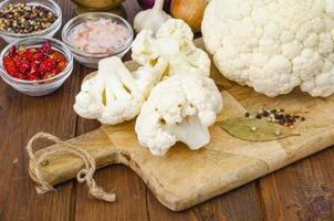 Head of cabbage fresh organic cauliflower on wooden background, spices. Studio Photo