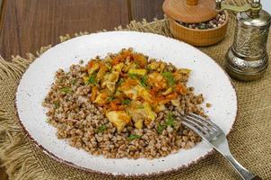 Buckwheat porridge with meat and vegetables. Studio Photo