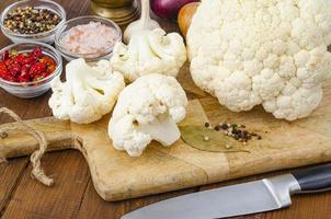 Head of cabbage fresh organic cauliflower on wooden background, spices. Studio Photo