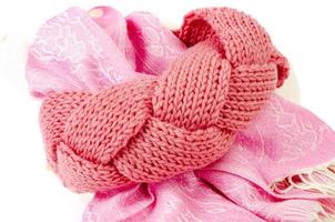 Beautiful pink headband, knitted from threads. Studio Photo