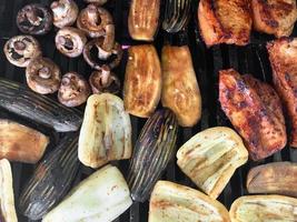 Pieces of vegetables and meat are grilled photo