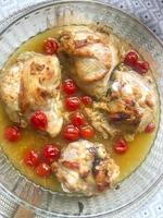 Poultry dishes. Chicken pieces with cherry tomatoes photo