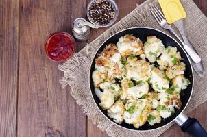 Cauliflower in batter, fried in pan. Studio Photo