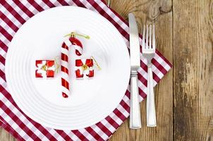 Christmas and New Years concept. White plate, red tablecloth. Studio Photo