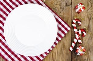 Christmas and New Years concept. White plate, red tablecloth. Studio Photo