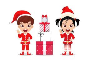 Lindo niño hermoso personaje de niño y niña vistiendo traje de Navidad y saludando coloridos y sosteniendo cajas de regalo y saludando vector