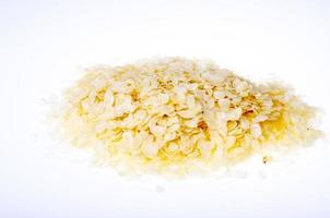 Raw flattened rice flakes isolated on white photo