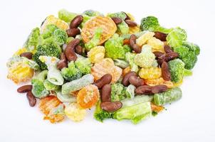 Pile of frozen raw vegetable pieces isolated on white background. Studio Photo. photo