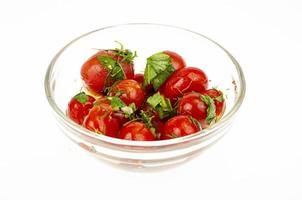 Pickled tomatoes with herbs and garlic. Studio Photo. photo