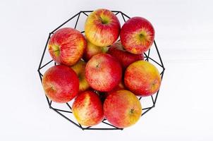 Ripe sweet apples in black metal basket. Studio Photo