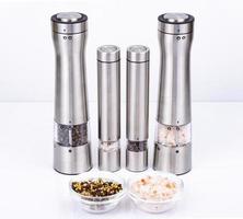Metal grinders for peppercorns and salt crystals. Studio Photo.
