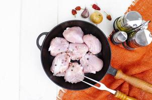 Raw pieces of chicken leg in skillet for cooking. Studio Photo. photo