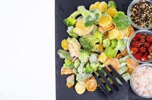 Mix of frozen vegetables on black. Studio Photo. photo