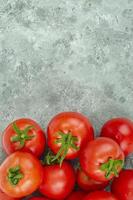 Bunch of ripe tomatoes on blue-gray background. Studio Photo