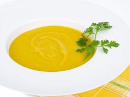 White plate with thick pumpkin cream soup. Studio Photo. photo