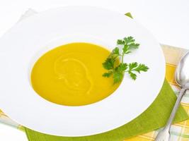 White plate with thick pumpkin cream soup. Studio Photo. photo