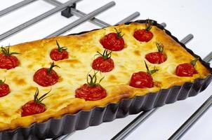 Homemade baking. Cherry tomato snack pie. Studio Photo. photo