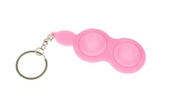 Pink keychain for two simple dimples, pop it. Fashionable and modern anti stress toy for children and adults photo