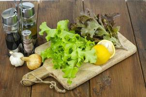 lettuce leaves on wooden cutting board, set of spices for cooking. Studio Photo. photo