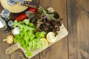 lettuce leaves on wooden cutting board, set of spices for cooking. Studio Photo. photo