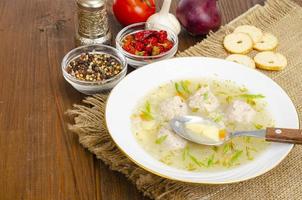 White plate of meatball soup. Studio Photo