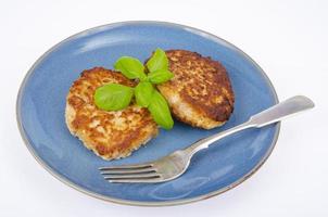 Blue plate with two minced meat cutlets. Studio Photo